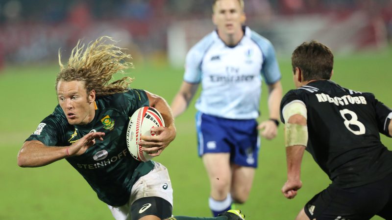 South Africa take on New Zealand during a Sevens World Rugby Dubai Series match. The event attracts 100,000 fans over three days