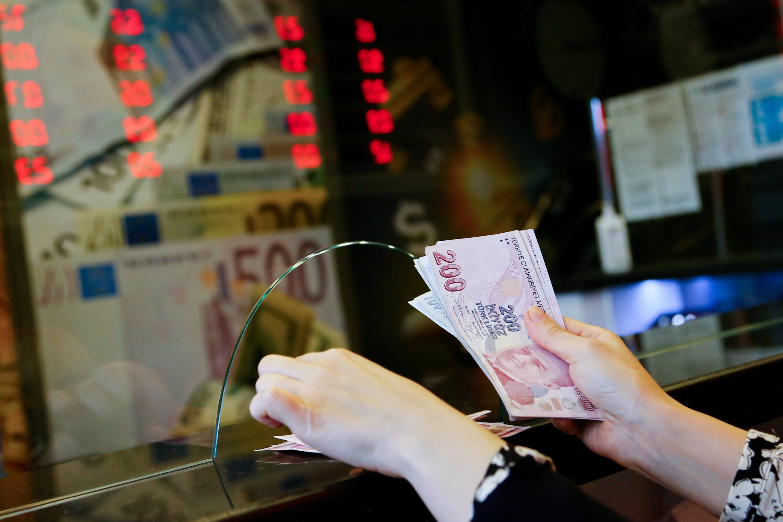 A worker counts Turkish lira at a currency exchange in Ankara. S&P Global Ratings this month upgraded Turkey to 'stable' from 'negative'