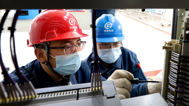 Workers inspect equipment at a hydropower plant in Zhangye, northern China. About 41% of renewables jobs are in China