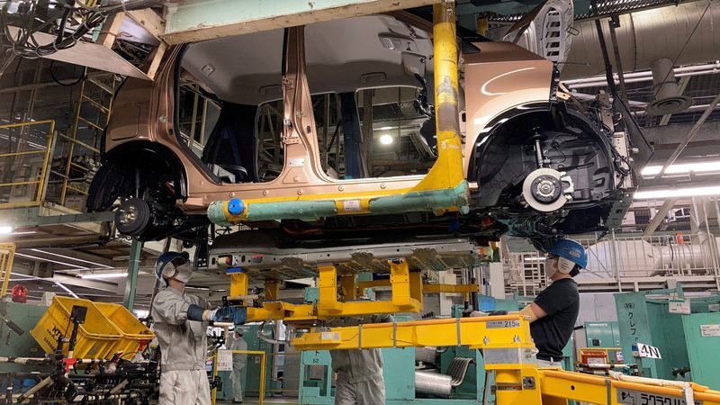 Workers at a Mitsubishi factory in Japan install an EV battery. Morocco has 70% of the world's phosphate, a vital material for batteries