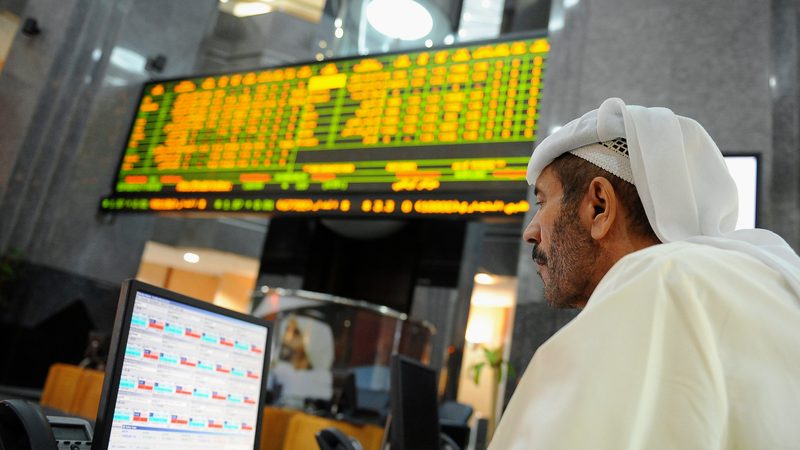 An investor studies a screen at the Abu Dhabi Securities Exchange