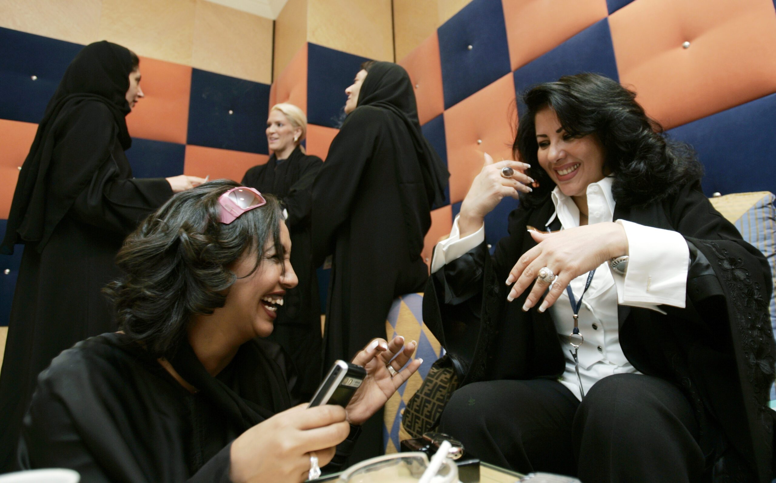 Saudi profiessional women having a conversation and laughing