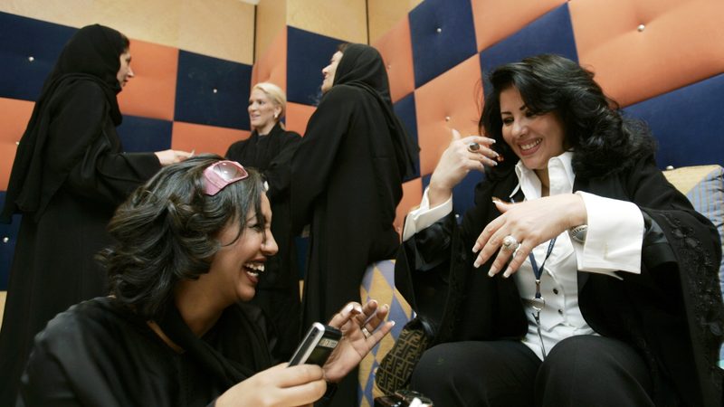 Saudi profiessional women having a conversation and laughing