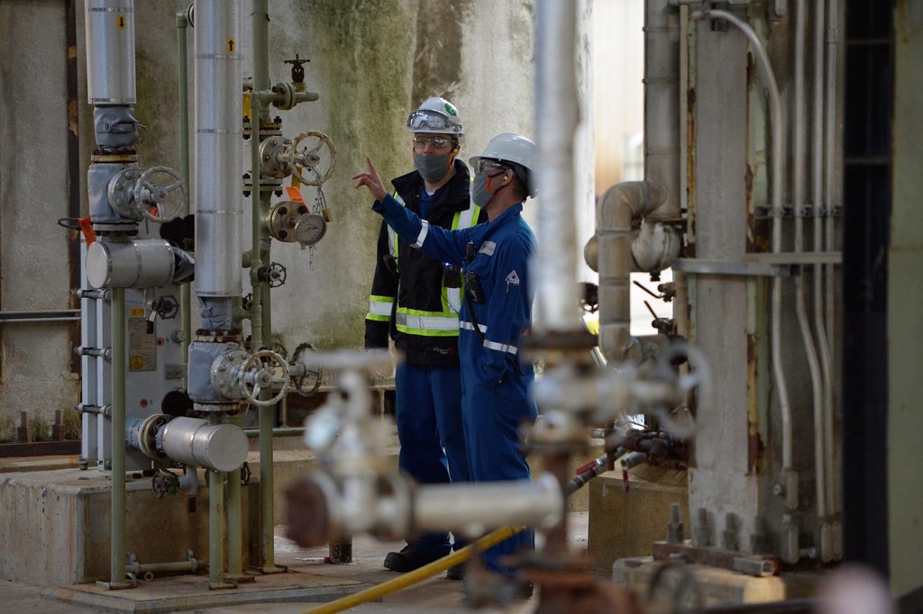 Workers at an oil refinery in British Columbia. New supply has opened up in Venezuela, Brazil and Guyana, as well as Canada