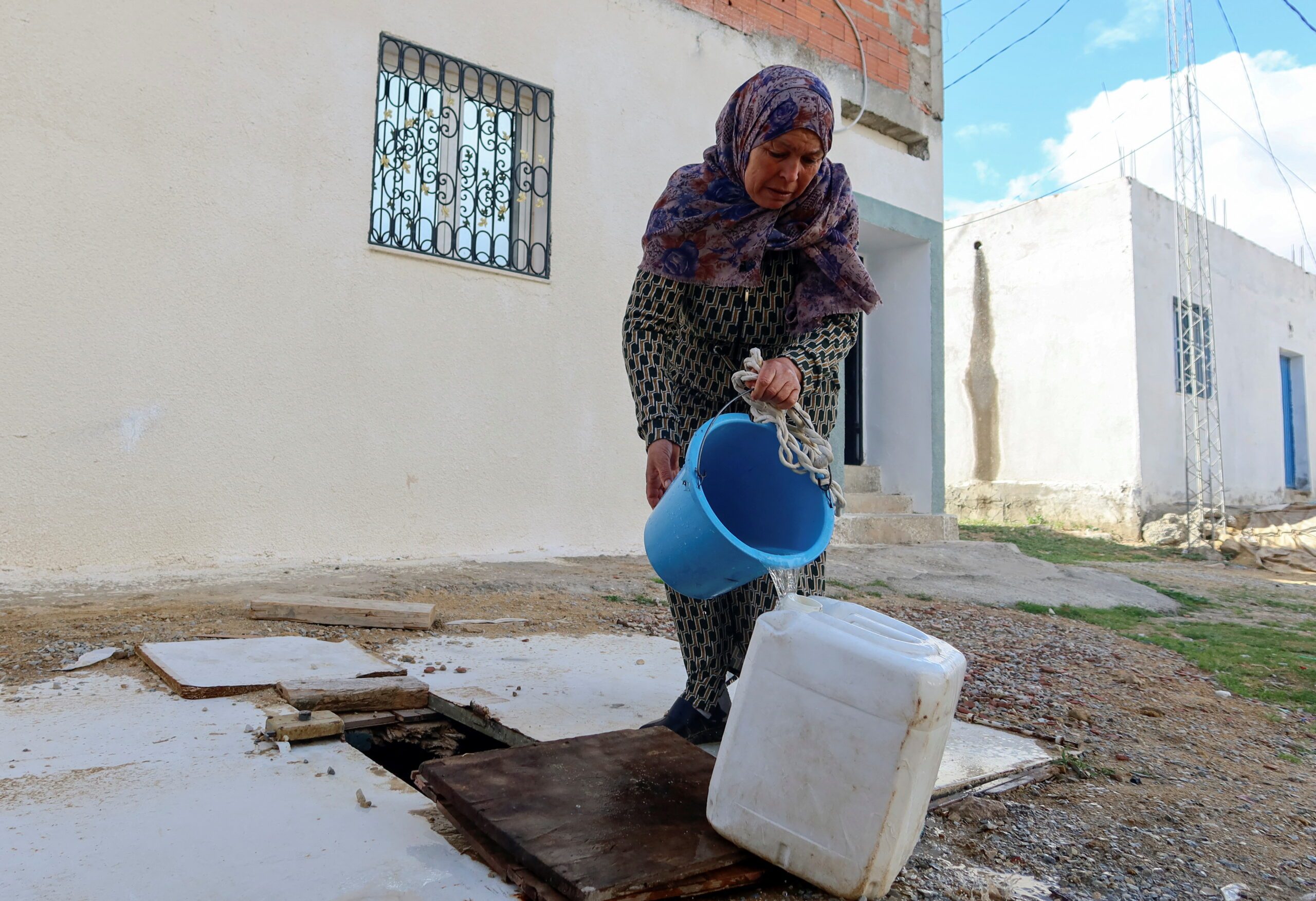 A woman collects water from a well in Tunis. Tunisia is having to operate a quota system for tap water