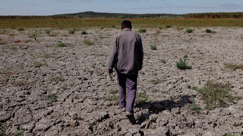 A farmer walks on a dried lakebed in Turkey. The UAE's water paper says 1.8 billion people live under conditions of absolute water scarcity