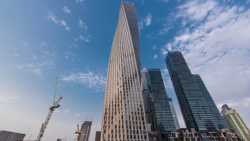 Accumulated losses for DSI, constructor of the Cayan Tower, Dubai, increased to AED5.3 billion in the first half of 2023 Cayan Tower Dubai Marina skyline blue sky