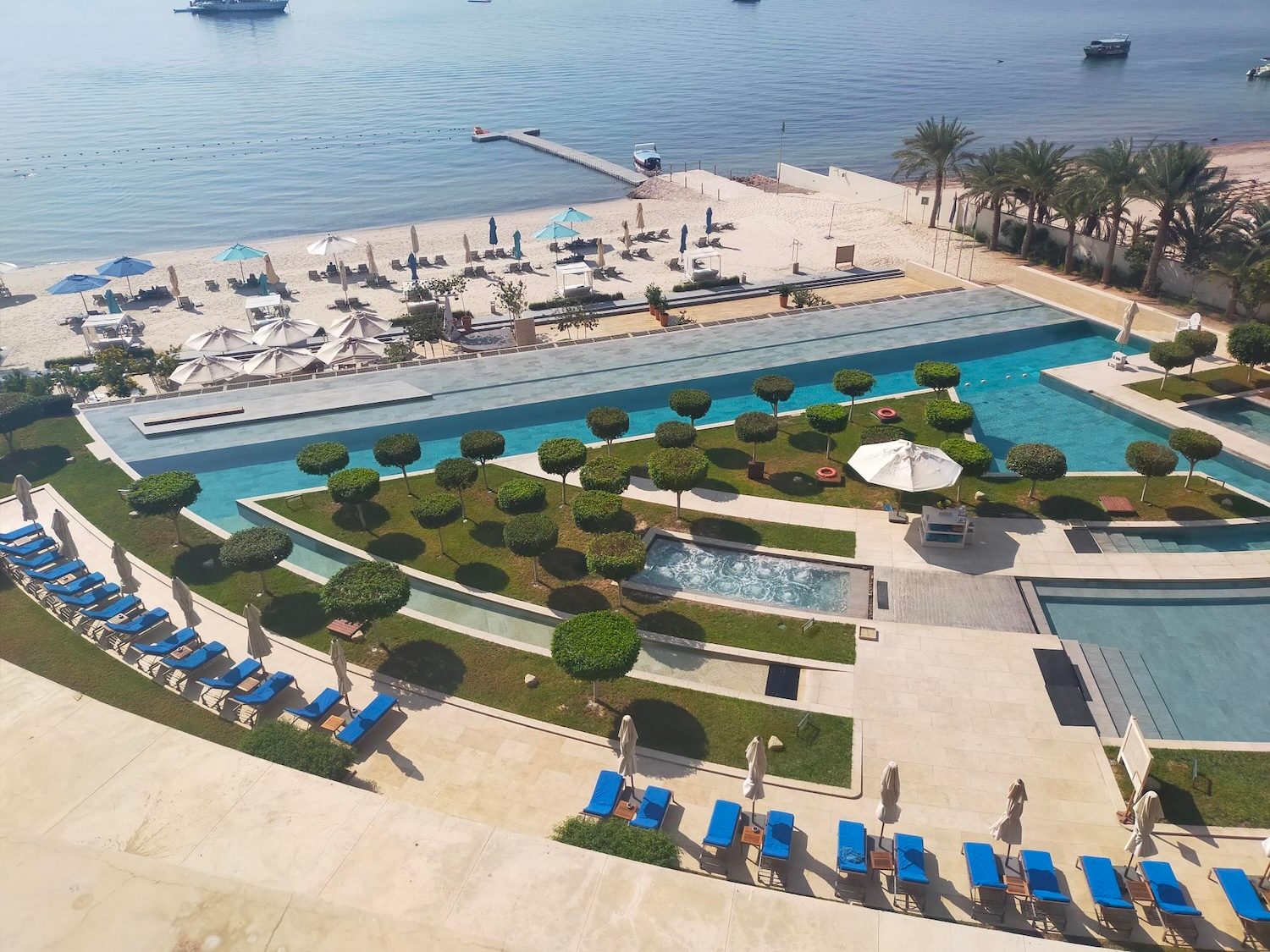 Sunbeds lie empty around the pool at the Kempinski hotel in Aqaba