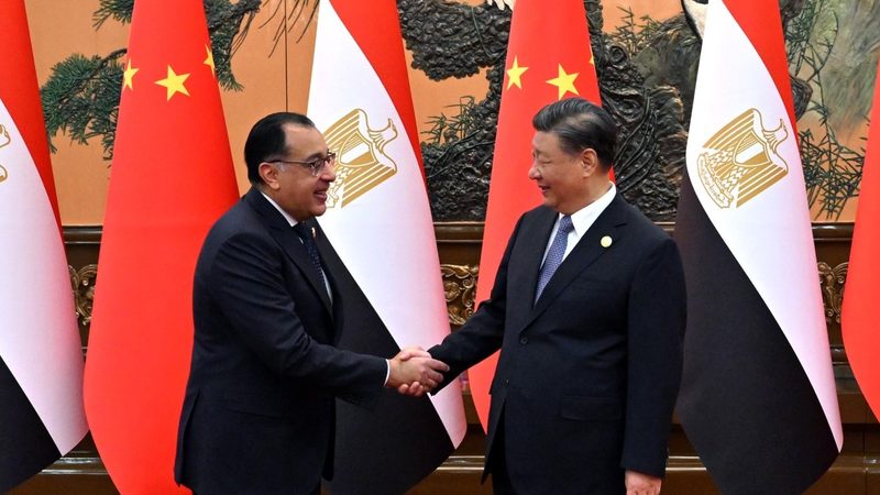 Egypt's PM Mostafa Madbouly greets President Xi Jinping at the Great Hall of the People in Beijing