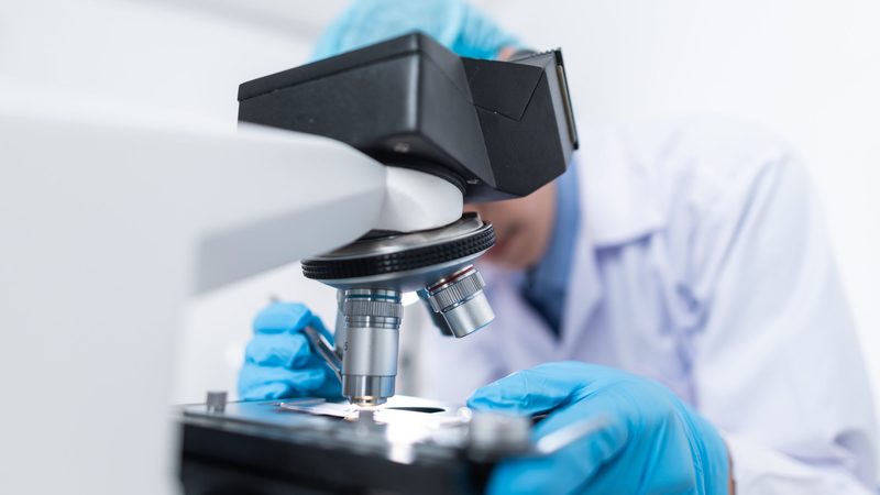 Investors are looking closely at opportunities in the healthcare sector scientist medicine microscope