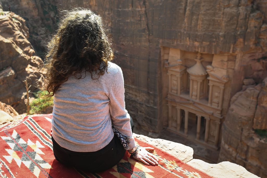 A tourist enjoys a view of Petra's most elaborate ruin, Al Khazneh (the Treasury), from the mountain above. On Thursday, February 8, 2019, in Petra, Ma'an Governorate, Jordan.