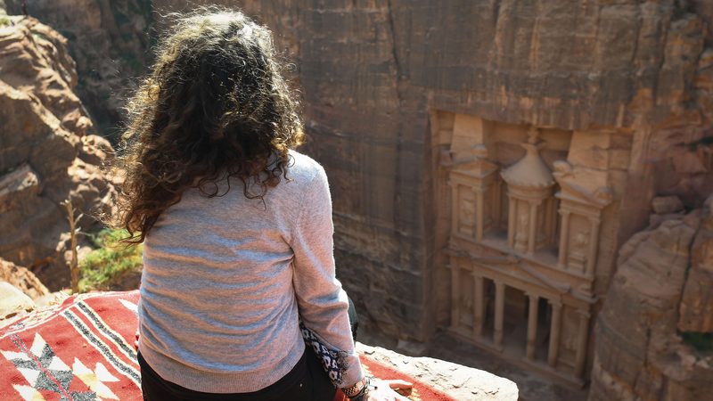 A tourist enjoys a view of Petra's most elaborate ruin, Al Khazneh (the Treasury), from the mountain above. On Thursday, February 8, 2019, in Petra, Ma'an Governorate, Jordan.