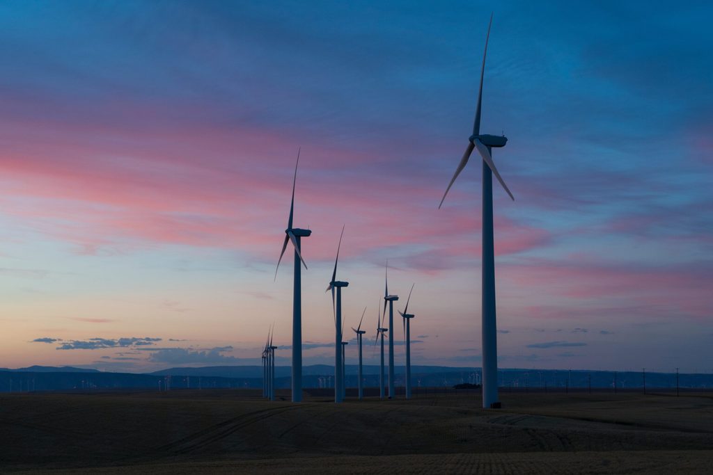 Wind turbines against pink and blue sky