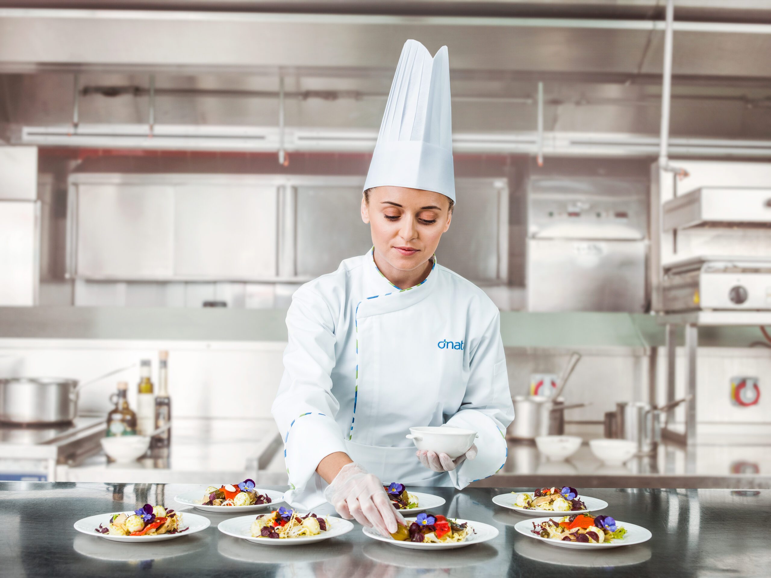 Woman chef arrsanging food at dnata