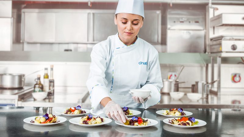 Woman chef arrsanging food at dnata
