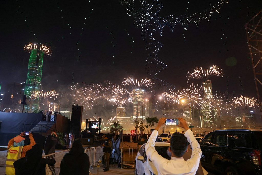 People watch fireworks and a light show as Saudi Arabia celebrates winning its bid to host the World Expo 2030 in Riyadh