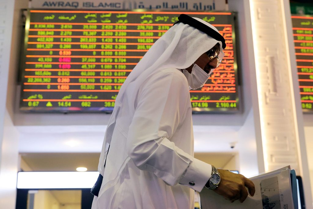 An investor walks through the Dubai Financial Market. The emirate's stock exchange is expected to outperform in 2024