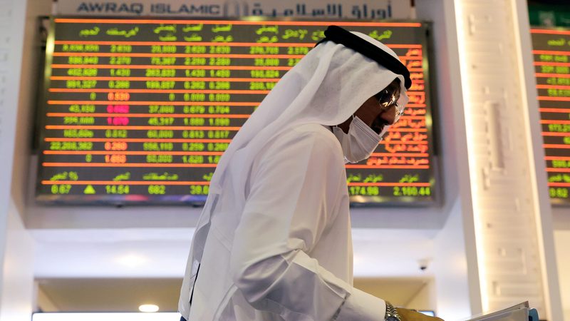 An investor walks through the Dubai Financial Market. The emirate's stock exchange is expected to outperform in 2024