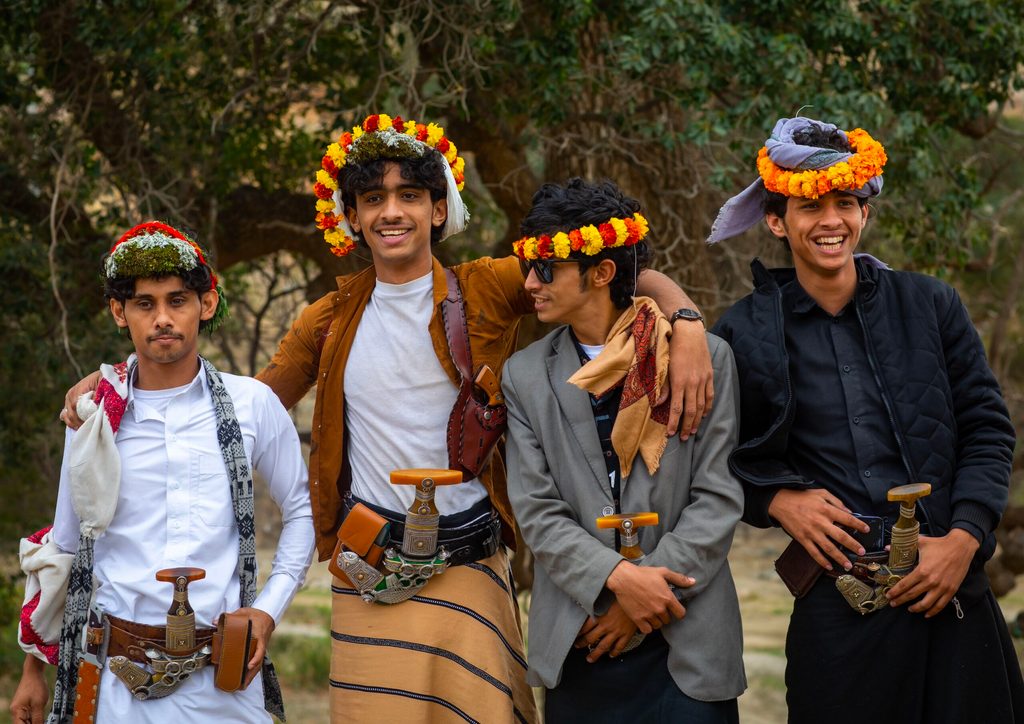 Young men in Aseer wearing its traditional floral crowns. The region's industrial, tourism and mining sectors are growing fast