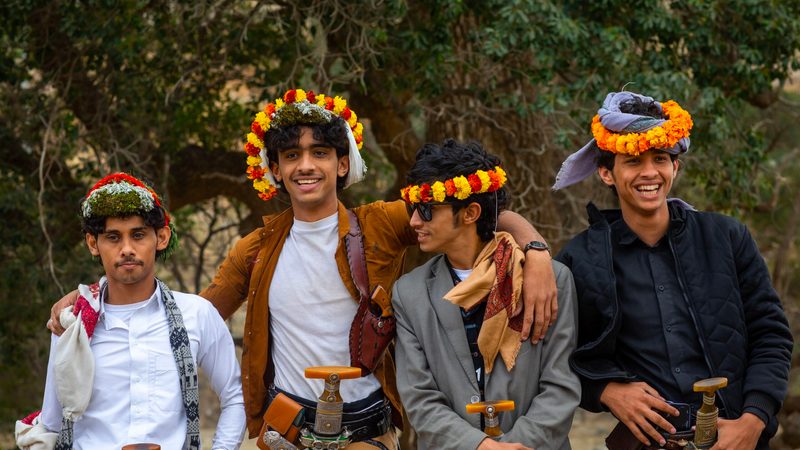 Young men in Aseer wearing its traditional floral crowns. The region's industrial, tourism and mining sectors are growing fast