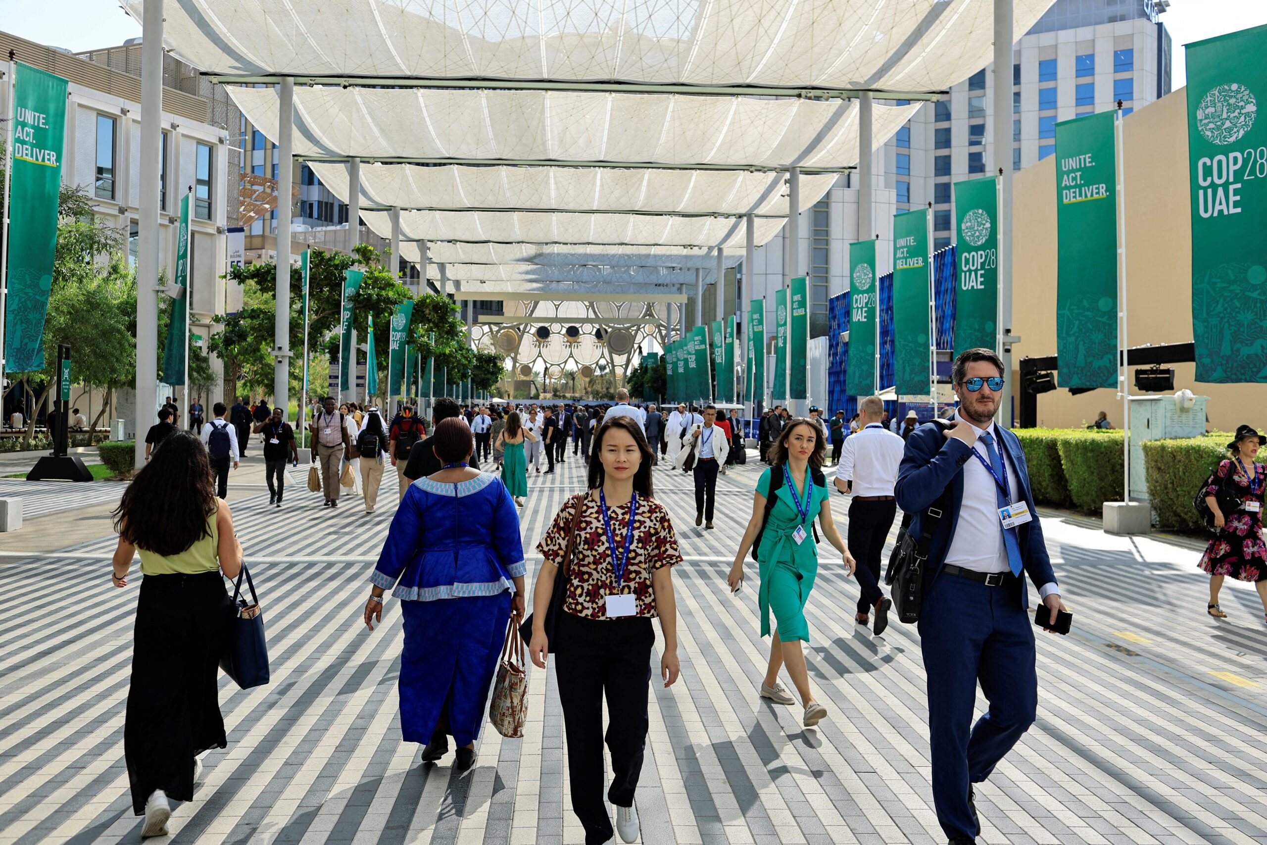 Cop28 delegates walk through Dubai's Expo City, possibly in search of Mr Toads Pub and Bar