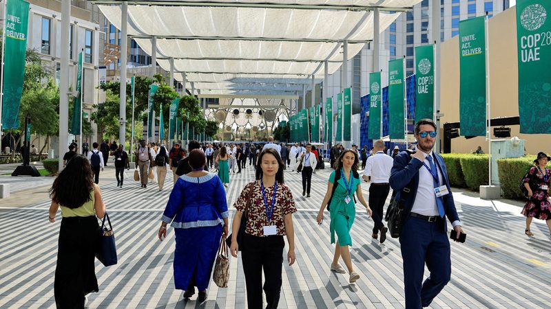 Cop28 delegates walk through Dubai's Expo City, possibly in search of Mr Toads Pub and Bar