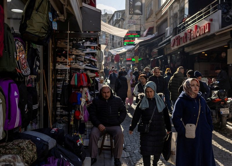 People walk through a shopping street in Istanbul on November 27, 2023