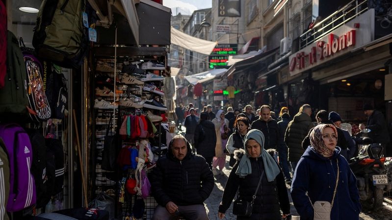 People walk through a shopping street in Istanbul on November 27, 2023