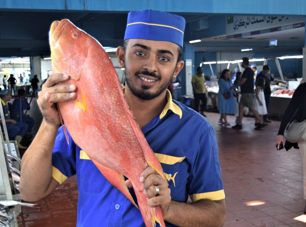 A seller in Jeddah's fish market, where freshly caught fish are sold at 100 stalls from 5am every day