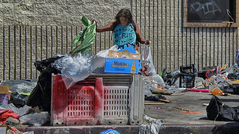 LA's Skid Row is a 'dystopian shanty-town of canvas and cardboard' where many people live roughnotorious Skid Row a woman salvages from rubbish in LA Skid Row trash waste