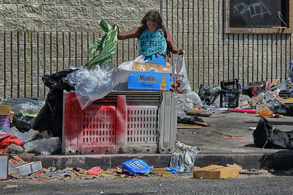 LA's Skid Row is a 'dystopian shanty-town of canvas and cardboard' where many people live roughnotorious Skid Row a woman salvages from rubbish in LA Skid Row trash waste