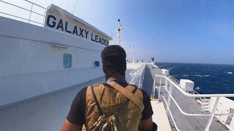 A Houthi fighter stands on the Galaxy Leader cargo ship in the Red Sea last month