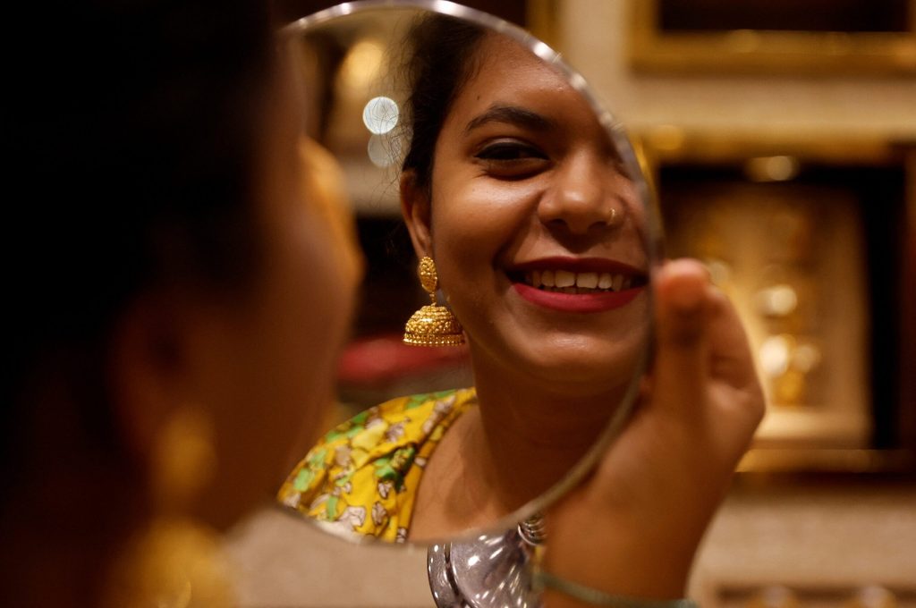 A woman checks her jewellery in Mumbai. The UAE’s top gold export market is India