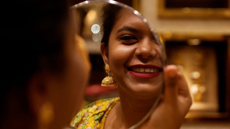 A woman checks her jewellery in Mumbai. The UAE’s top gold export market is India