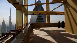 A visitor takes photos on the 71st floor of the Gevora Hotel, the world's tallest, in Dubai