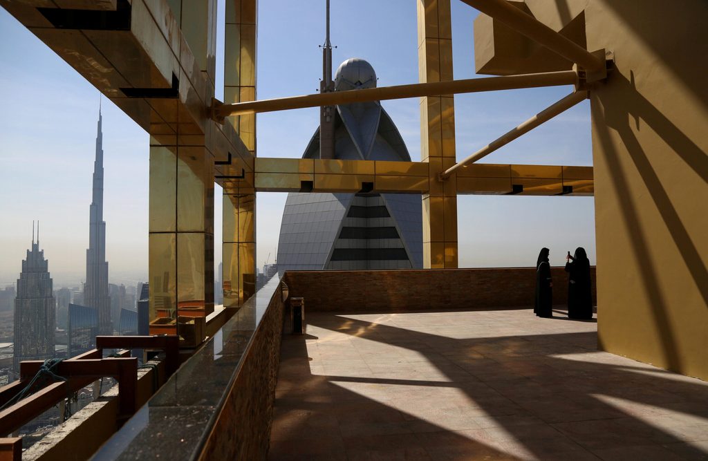 A visitor takes photos on the 71st floor of the Gevora Hotel, the world's tallest, in Dubai