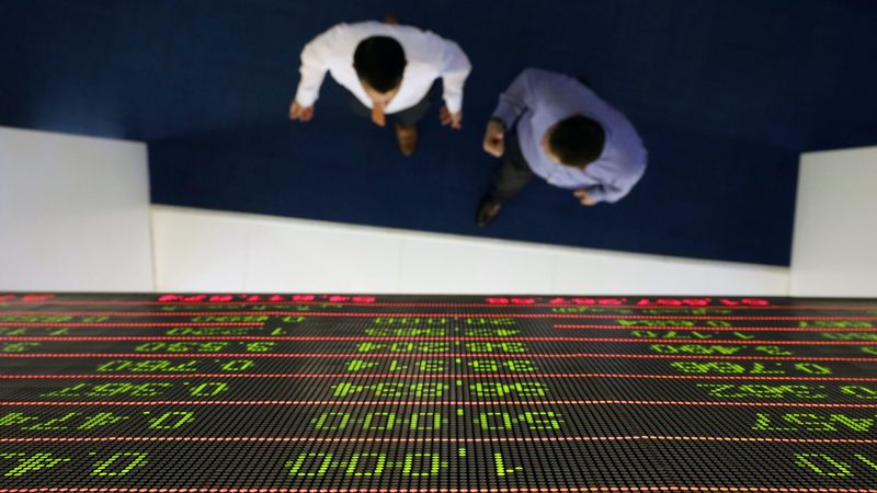 Investors at the Dubai Financial Market. Executives believe 'international strategic' buyers will be the most active in the Middle East this year