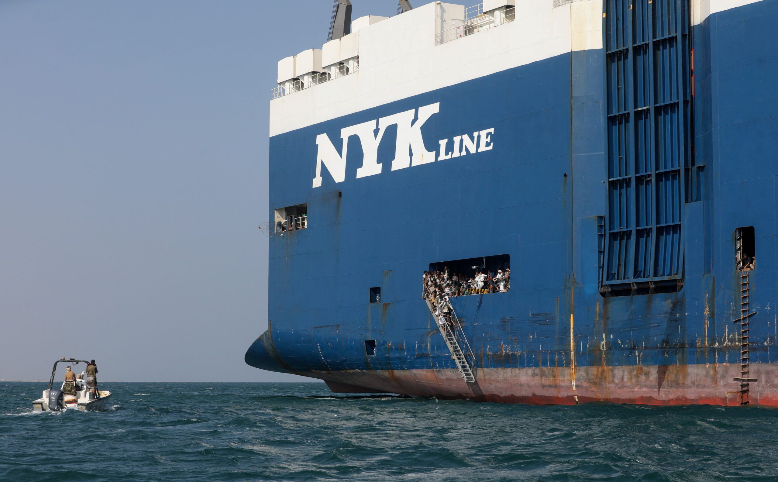 Sightseers wait for boats to take them back to land after they toured the Galaxy Leader commercial vessel, seized by Yemen's Houthis last month