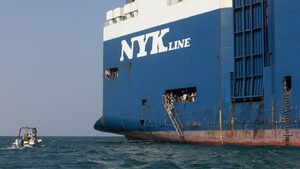 Sightseers wait for boats to take them back to land after they toured the Galaxy Leader commercial vessel, seized by Yemen's Houthis last month