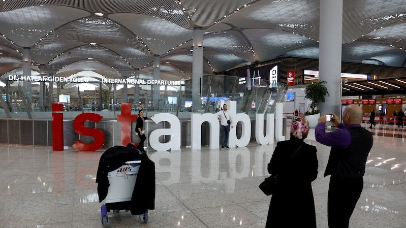 Passengers take photos at Istanbul Airport. Inflation reached 67.07 percent in February