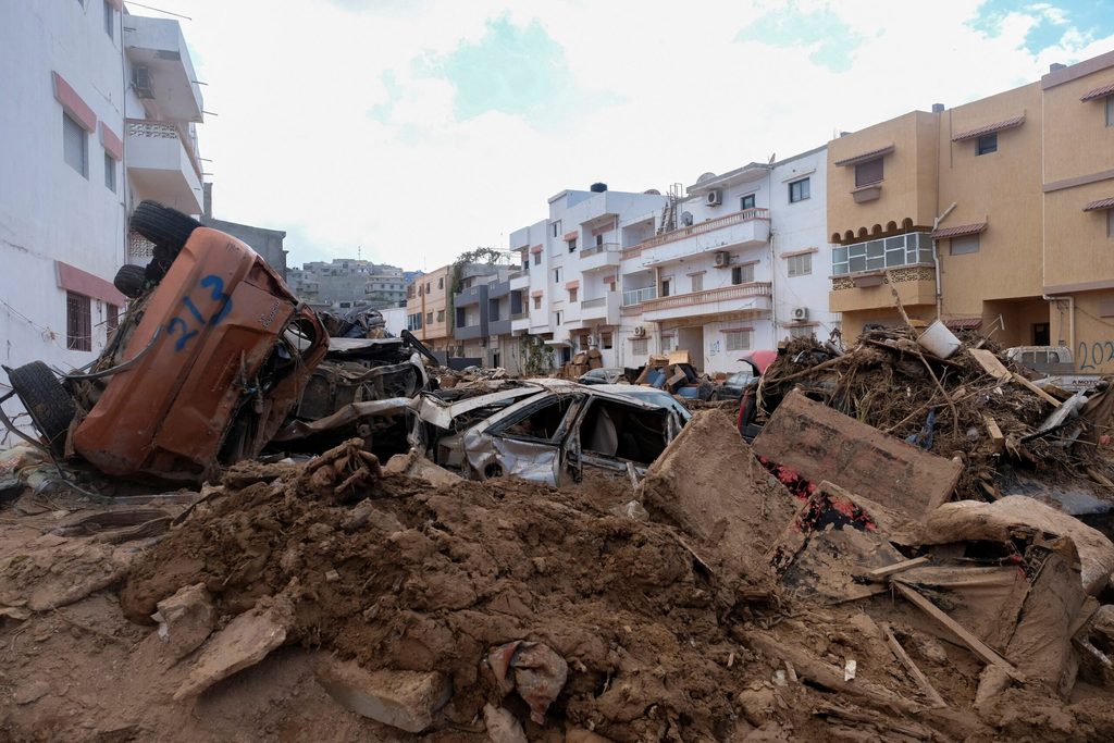 Cars in the rubble of Derna. Jabal Al Akhdar, Marj and Derna account for 75% of the $1.65bn damage and losses