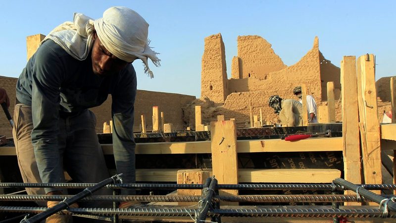A worker restoring the Diriyah district, one of the giga-projects Saudi Arabia is using a budget deficit to create