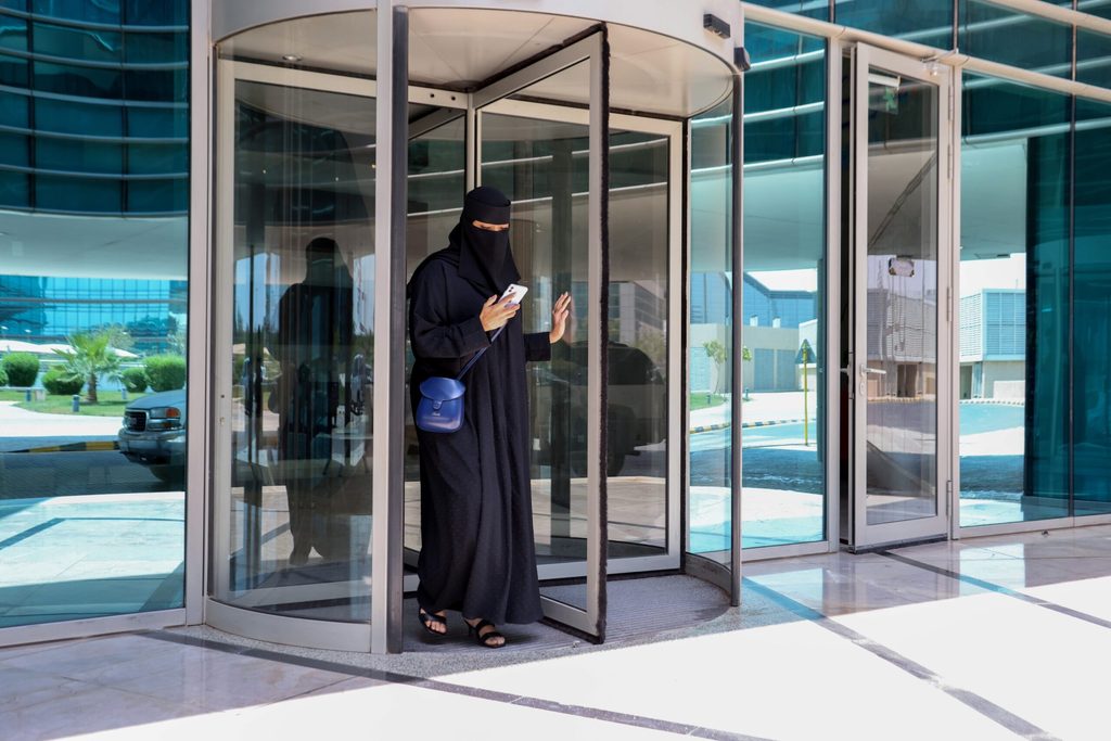 A Saudi woman leaves her office. Foreign companies are setting up HQs in the kingdom to gain access to government contracts