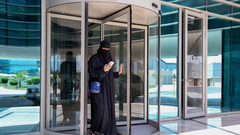 A Saudi woman leaves her office. Foreign companies are setting up HQs in the kingdom to gain access to government contracts
