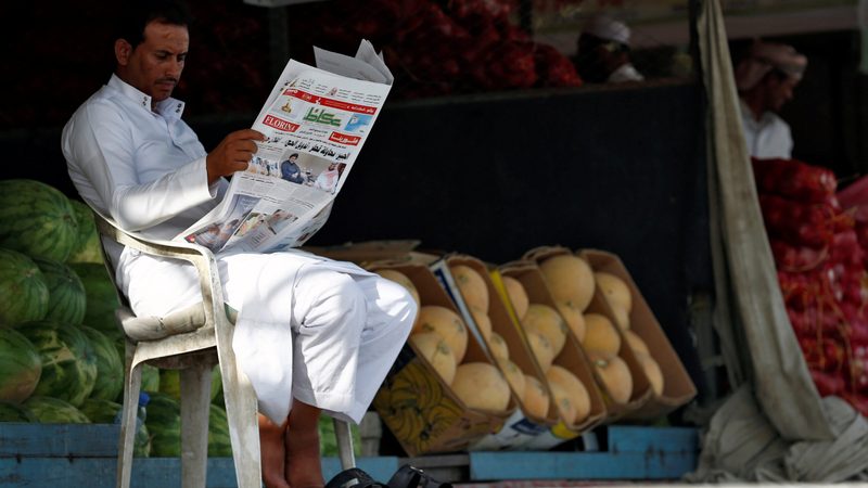 A market vendor reads a newspaper in Riyadh. Saudi media is 'way behind' where it ought to be, said one expert