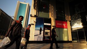 Men walk past an HSBC branch in Manama. HSBC Bank Middle East made pre-tax profit of $1.2bn in 2023
