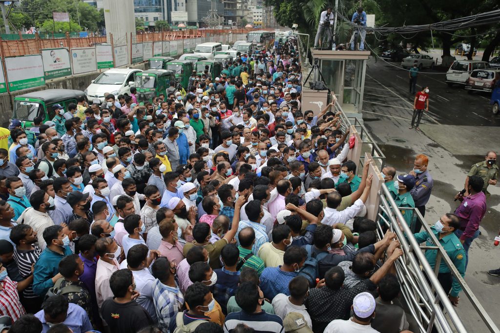 Workers in Bangladesh wait to travel to Saudi Arabia. Migrant workers have been sending remittances in smaller amounts.