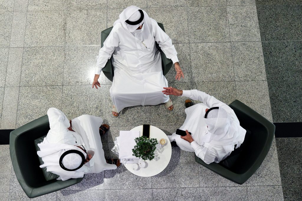 People speak in the lobby of the Dubai Financial Market. Strict IPO rules mean loss-making startups cannot go public