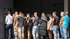 People queue to withdraw money from an ATM in Sidon, Lebanon. Parliament's passing of a budget in January is a significant sign of progress