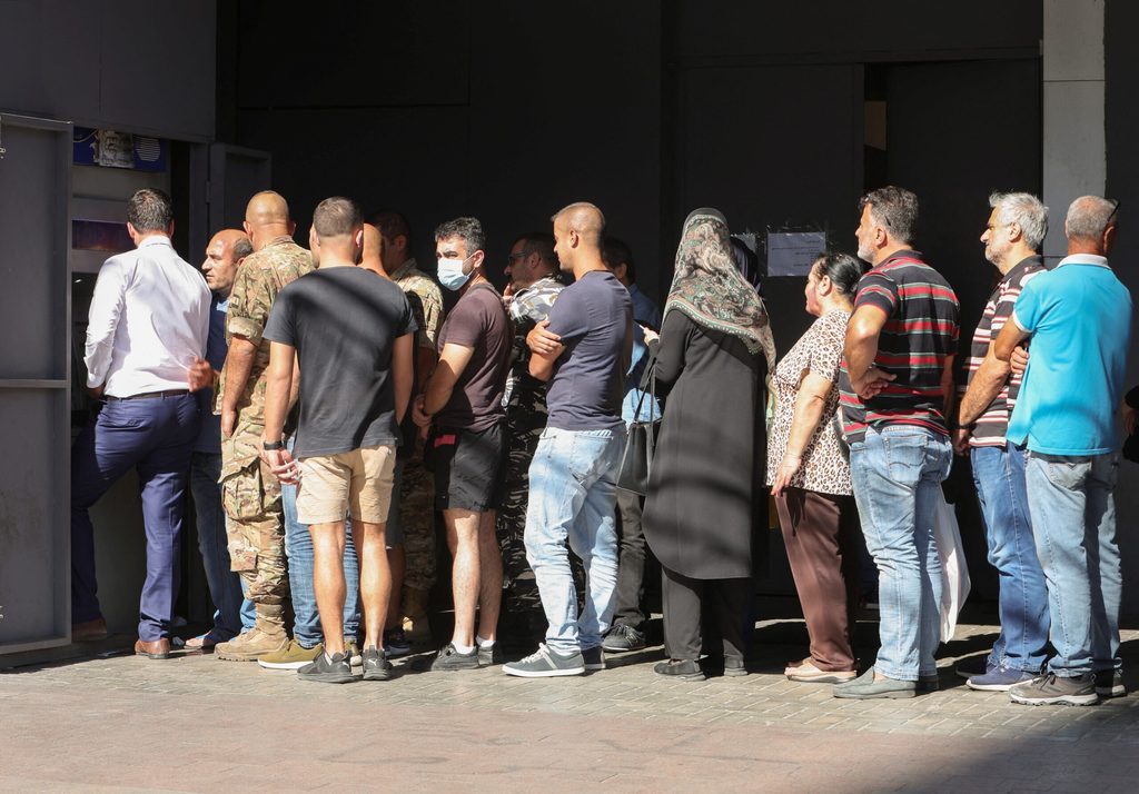 People queue to withdraw money from an ATM in Sidon, Lebanon. Parliament's passing of a budget in January is a significant sign of progress